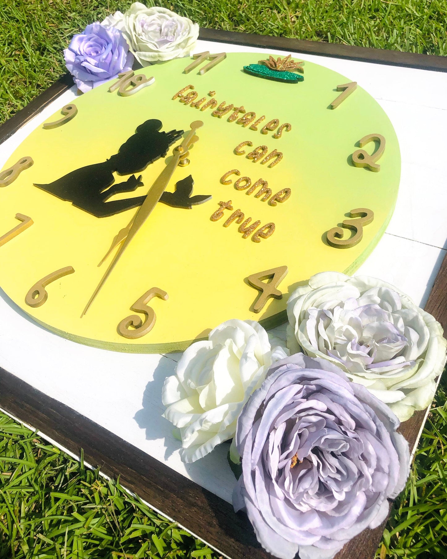 Decorative clock with floral elements on a grassy background