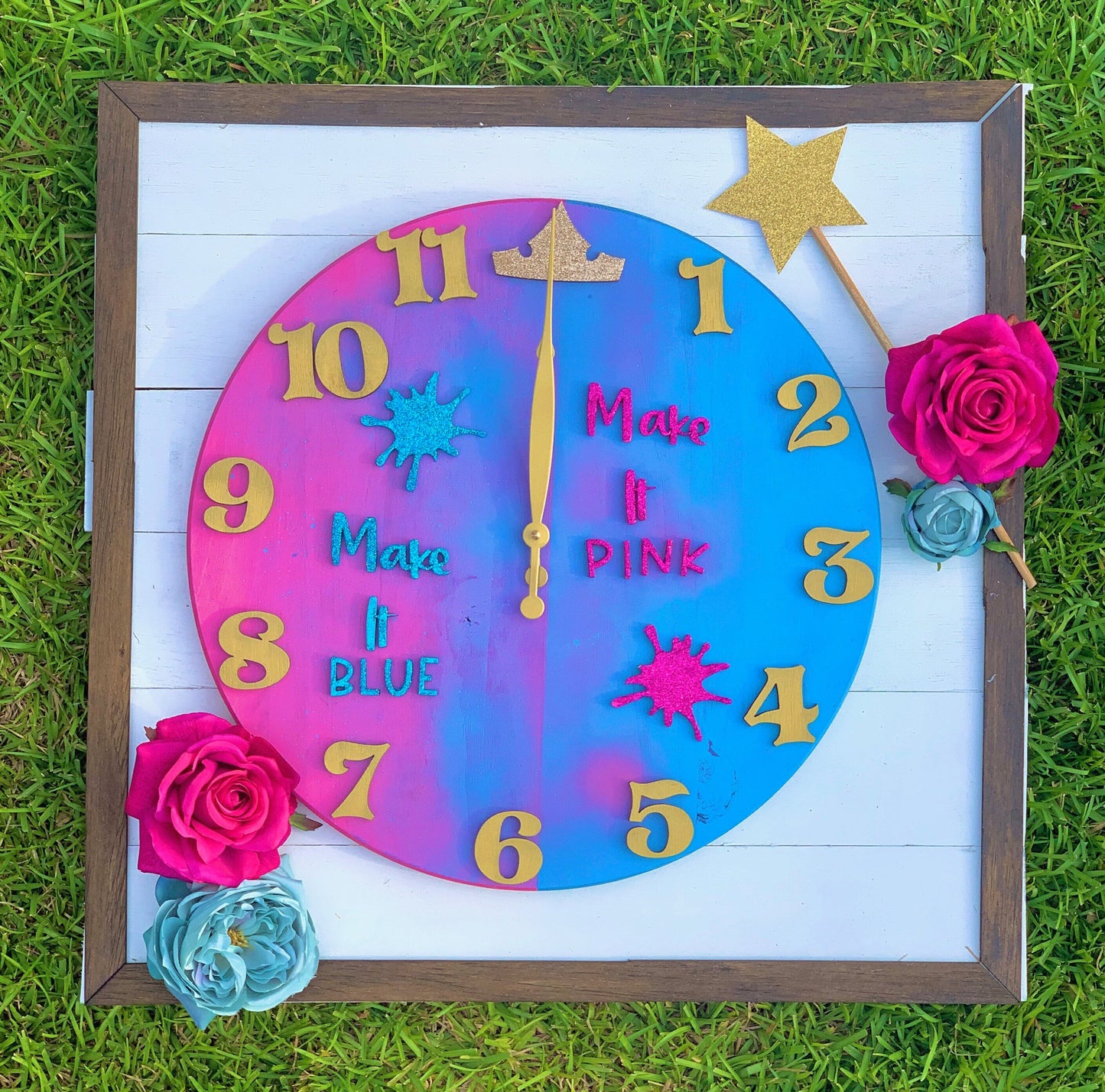 Colorful clock with floral decorations on a grass background