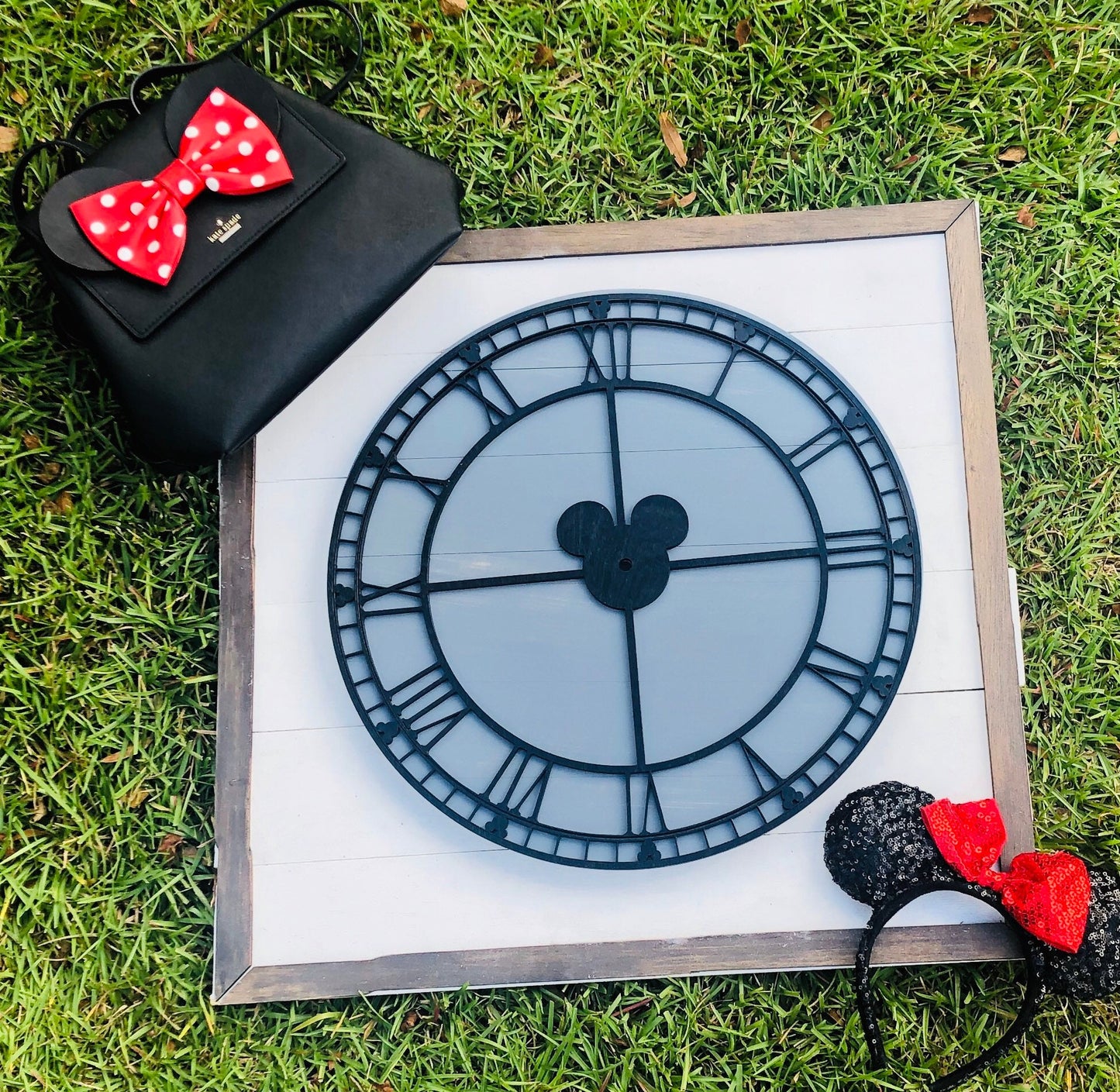 Decorative clock with Mickey Mouse design on a grassy background