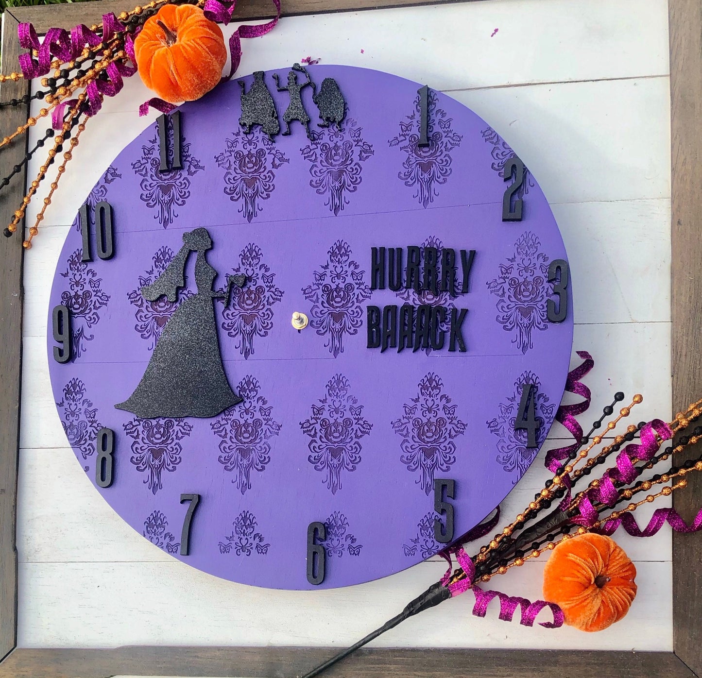 Decorative clock with Halloween theme on a wooden surface