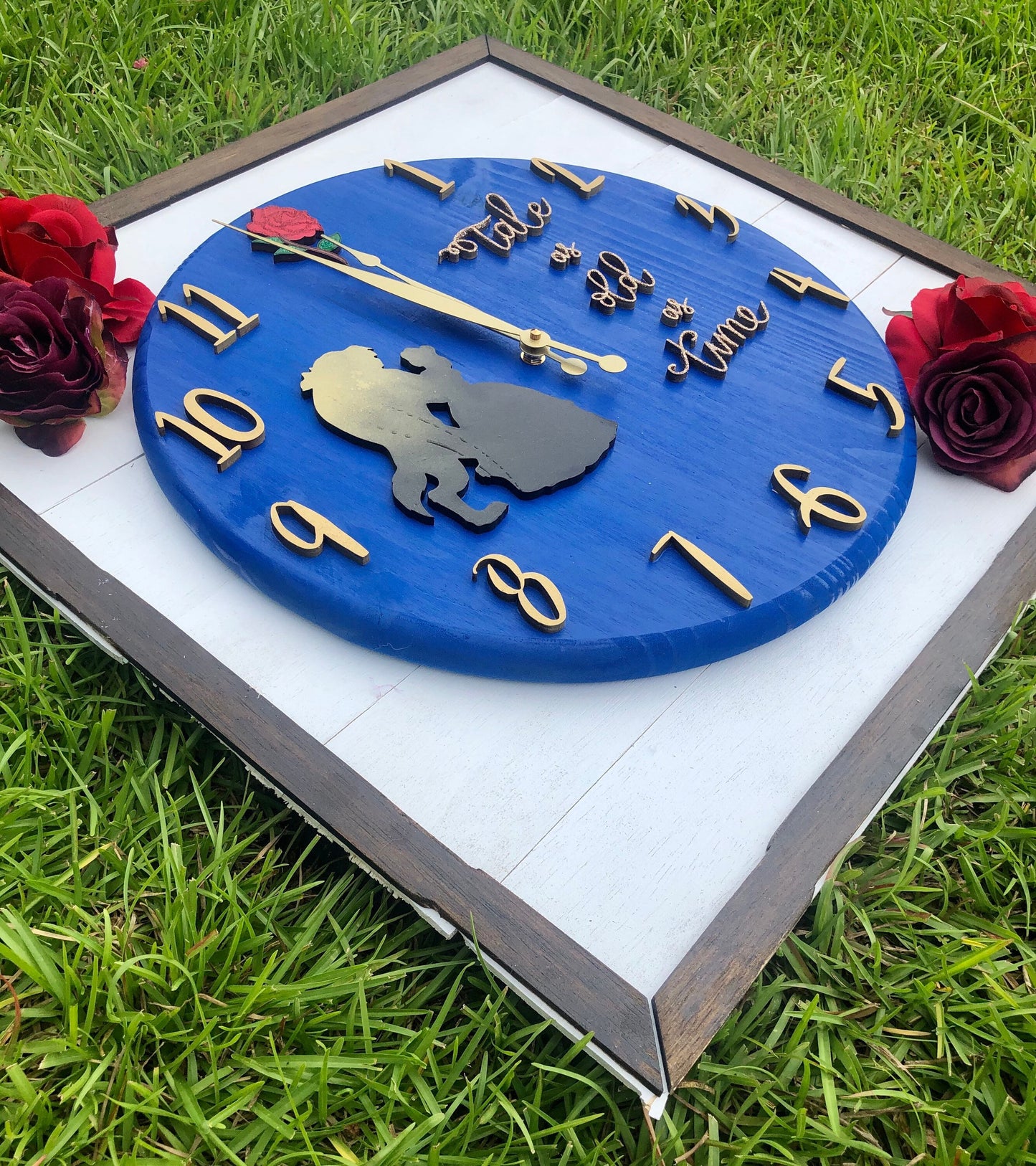 Decorative clock with silhouettes and numbers on a grass background