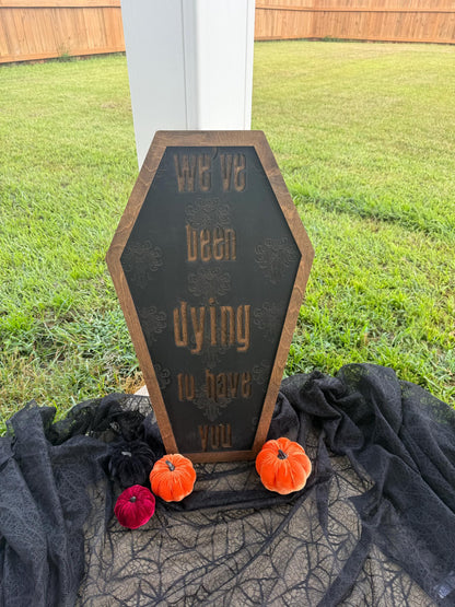 Decorative Halloween sign with pumpkins on a grassy background