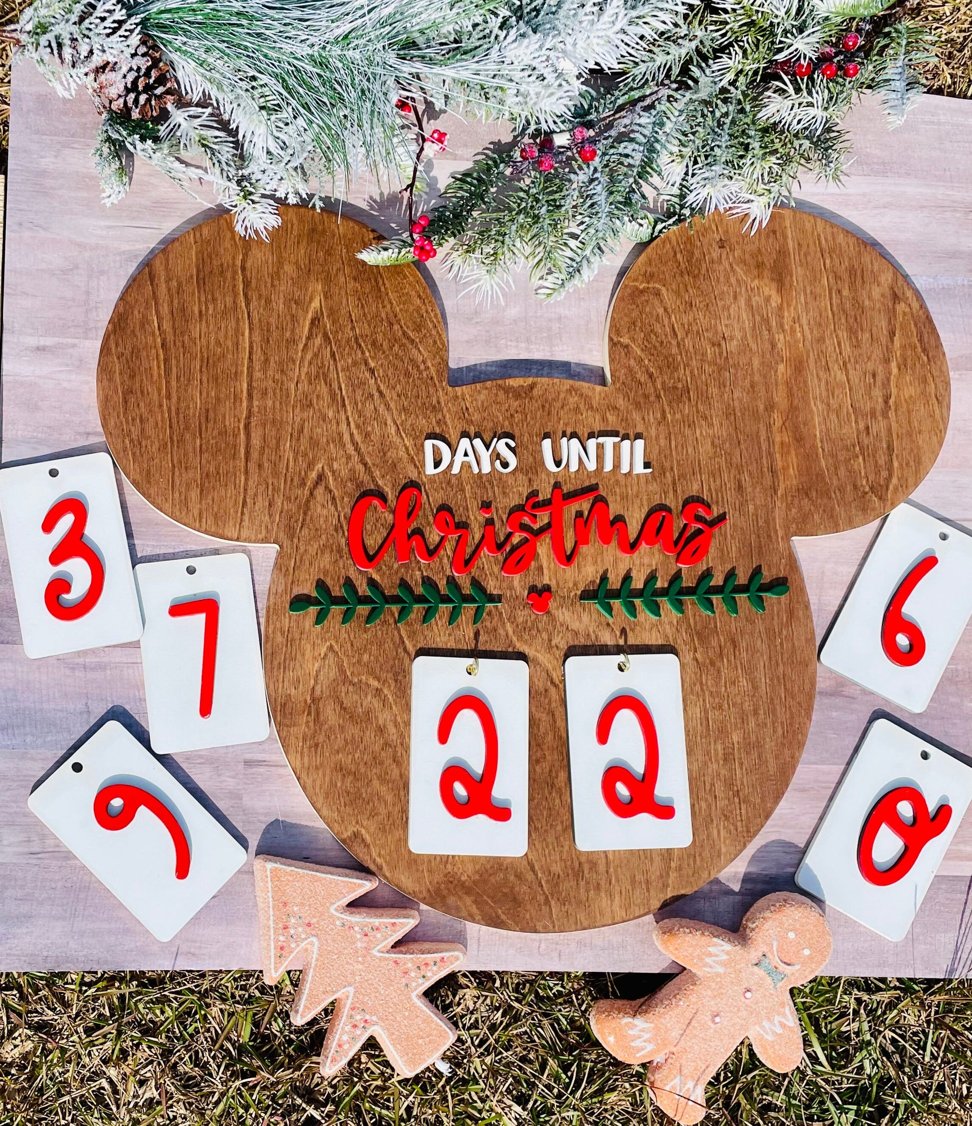 Wooden Christmas countdown calendar with decorative elements on a wooden surface.