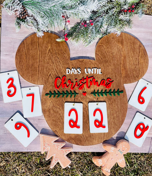 Wooden Christmas countdown calendar with decorative elements on a wooden surface.