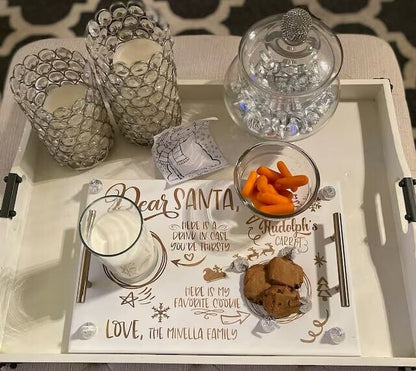 Tray with cookies, crackers, and a glass of milk for Santa on a decorative mat.
