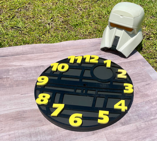 Circular object with yellow numbers on a wooden surface with grass in the background