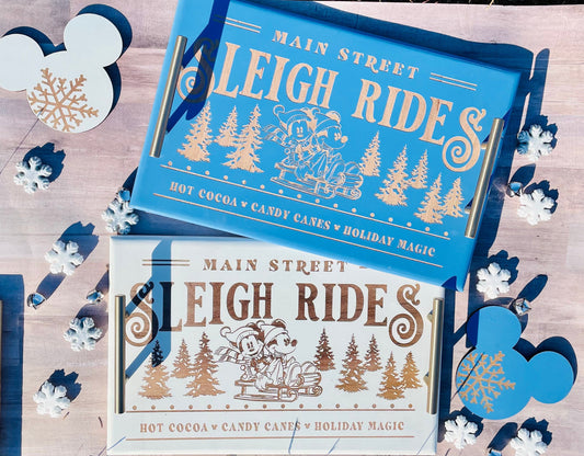Two 'Main Street Sleigh Rides' packages on a wooden surface with decorative snowflakes.