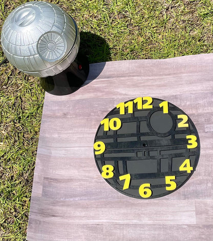 Dartboard shaped like a Death Star with numbers on a wooden board outdoors.