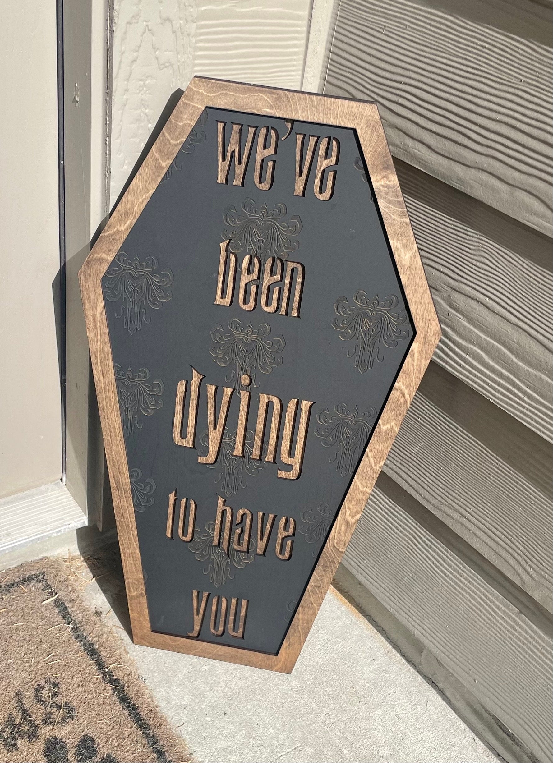 Hexagonal sign with decorative text on a neutral background