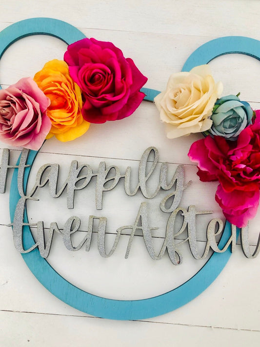 Decorative sign with 'Happily Ever After' surrounded by colorful flowers on a white background