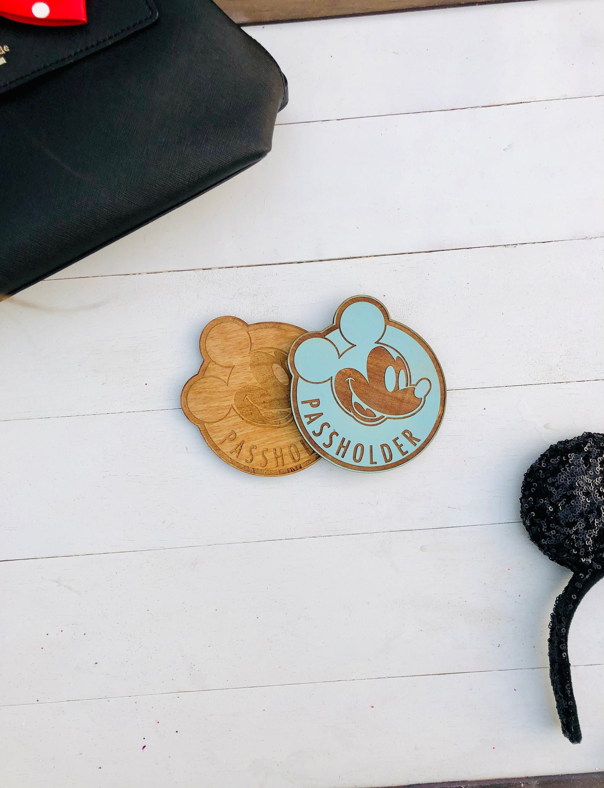 Wooden passholder with cartoon character design on a white surface