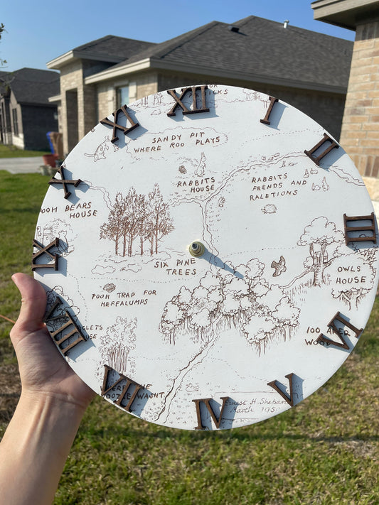 Person holding a circular map with illustrations and text, outdoors.