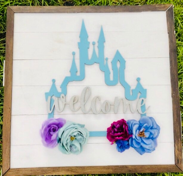 Decorative sign with castle design and flowers on a white background