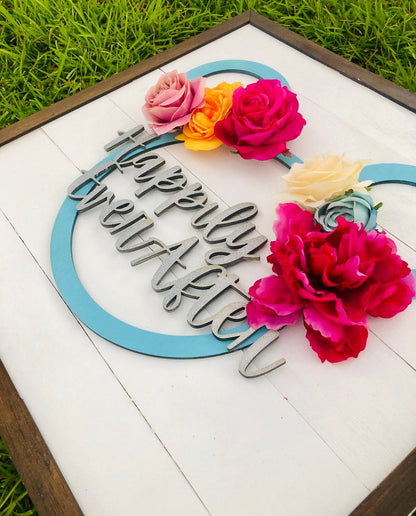 Decorative sign with flowers and 'Happy New Year' text on a grass background
