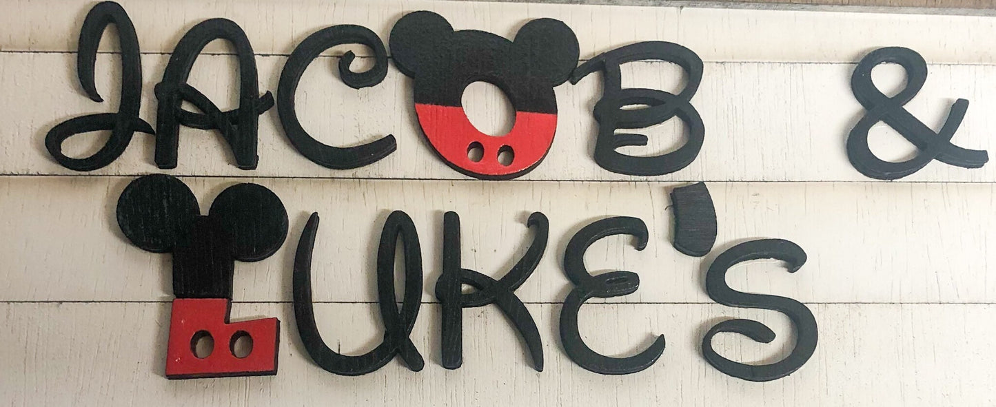Wooden name sign with Mickey Mouse ears for 'Jacob & Luke's' on a light wooden background