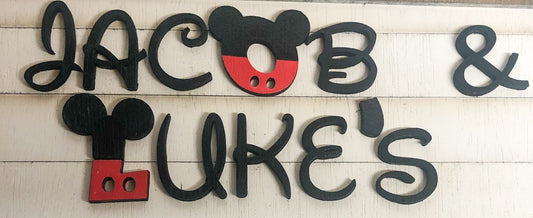 Wooden name sign with Mickey Mouse ears for 'Jacob & Luke's' on a light wooden background