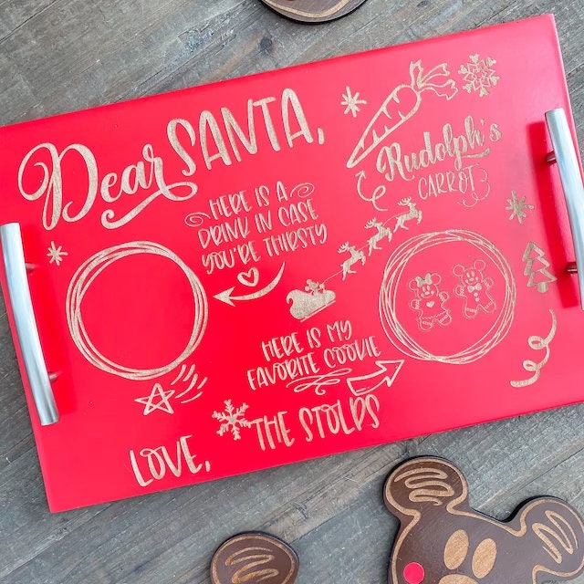 Red tray with Christmas-themed text and illustrations on a wooden surface