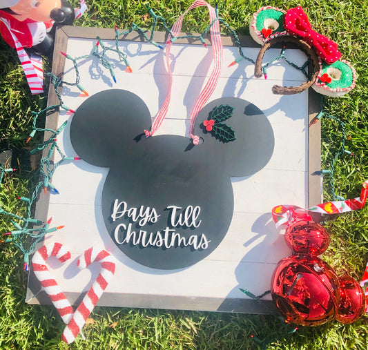 Christmas countdown sign with decorative elements on grass