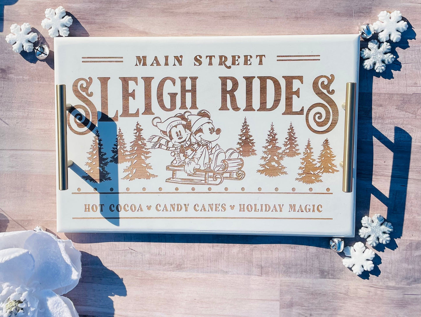 Advertisement for 'Main Street Sleigh Rides' with winter elements on a wooden background