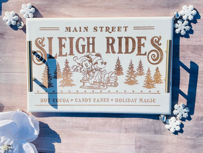 Advertisement for 'Main Street Sleigh Rides' with winter elements on a wooden background