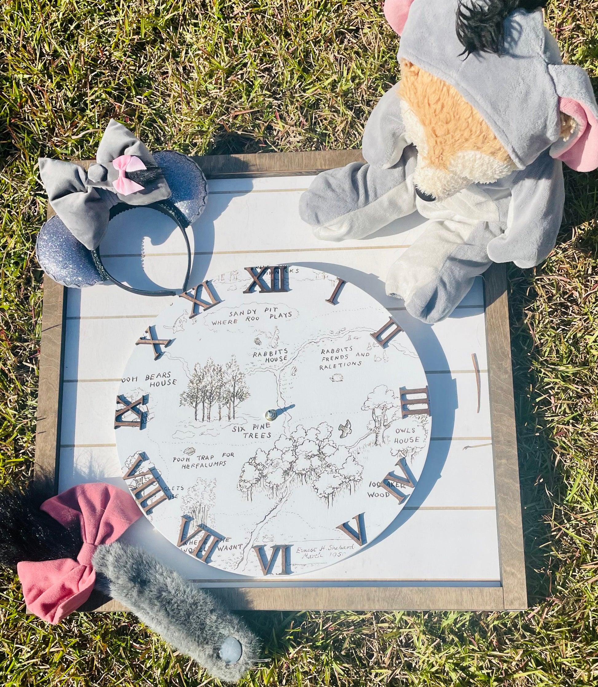 Plush toy elephant with decorative clock on grass