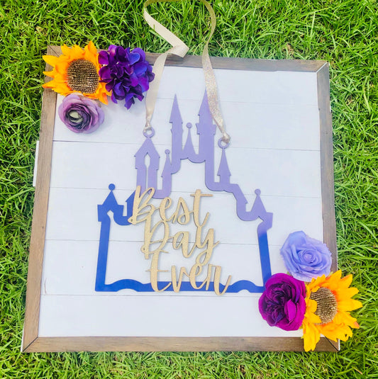 Decorative sign with castle design and 'Best Day Ever' text on grass