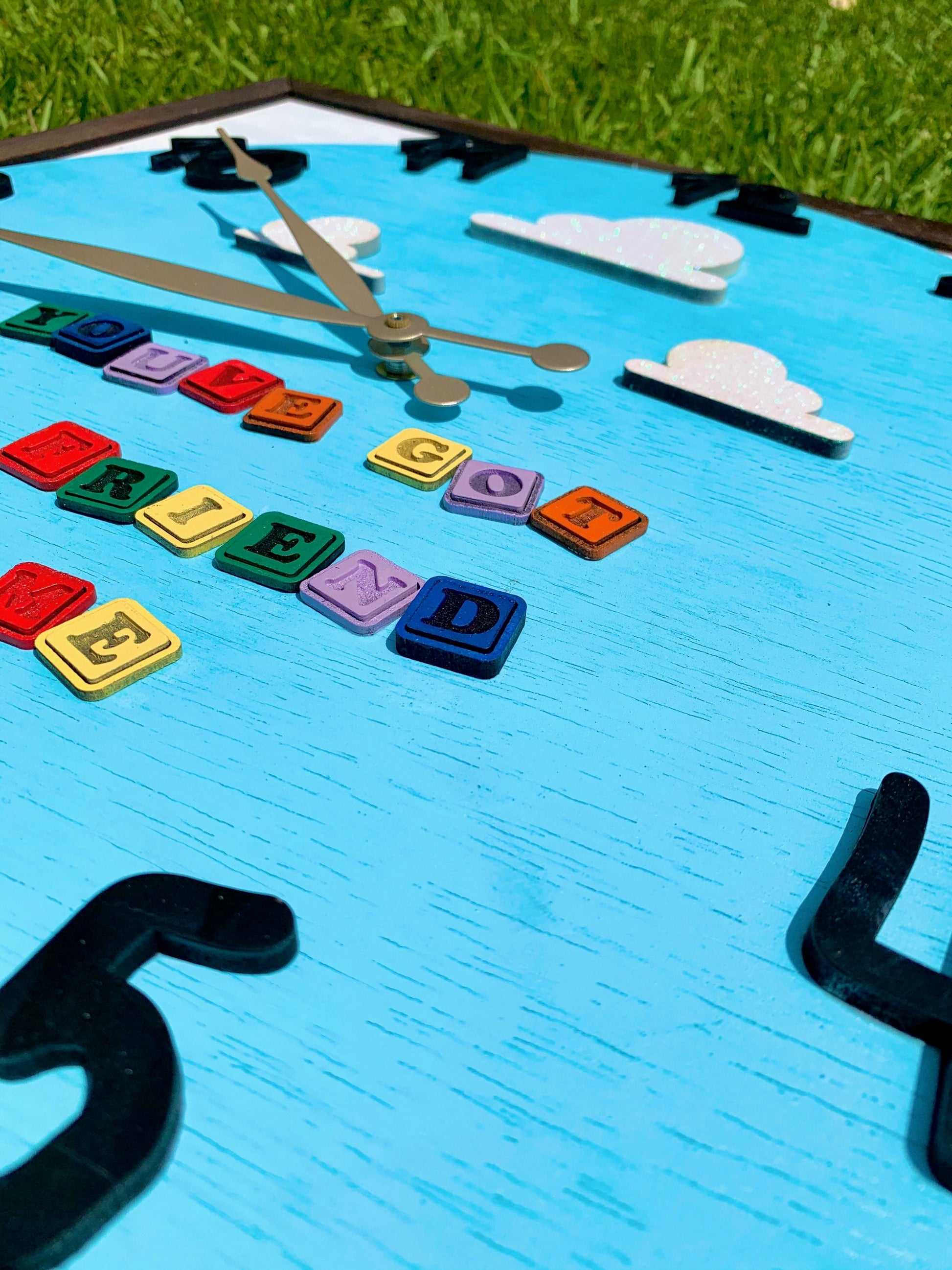 Colorful clock with letters on a blue background
