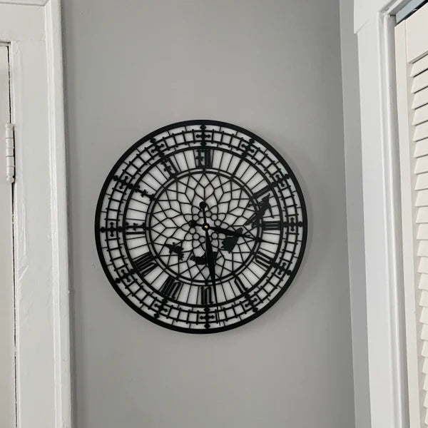 Decorative wall clock with intricate design on a plain wall.
