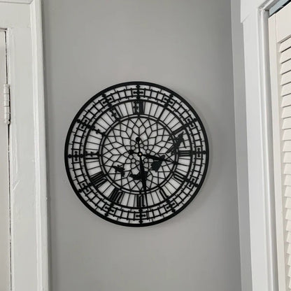 Decorative wall clock with intricate design on a plain wall.